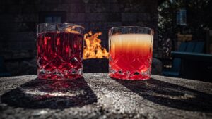 2 mimosa glasses with sitting on a table with a fire in the background